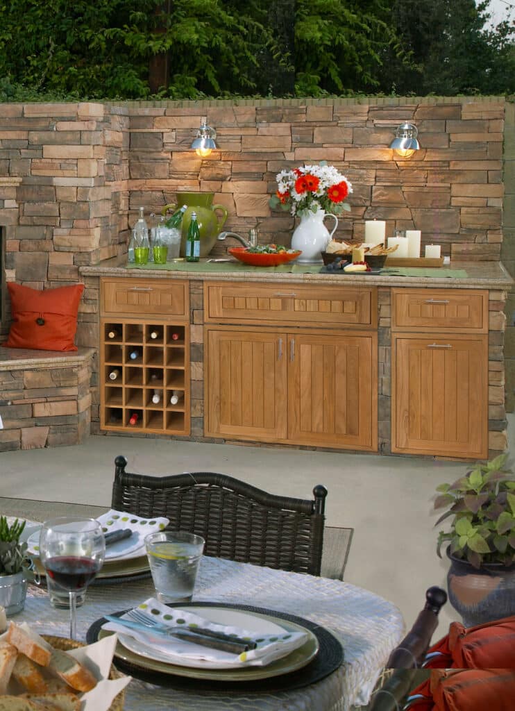Patio wine bar with solid teak cabinets and open wine storage in Naples