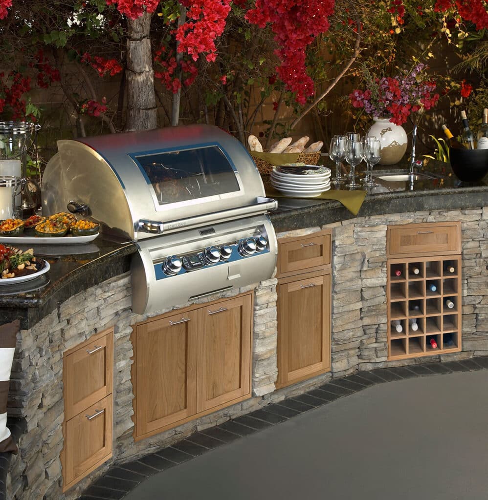 Curved stone island with teak cabinets and an integrated wine cabinet